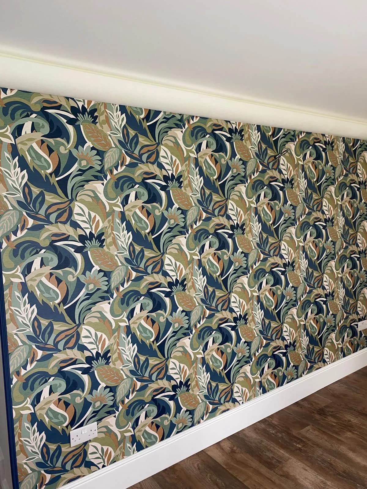 Botanical green and blue feature wall, freshly hung by Jason Sterne